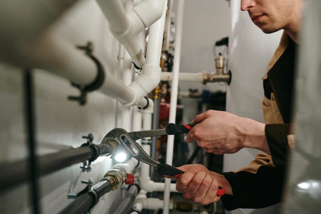Plumbers maintaining commercial plumbing pipes in Golden