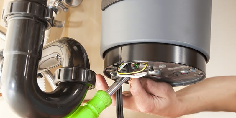 Technician repairing the heating element of a water heater in Golden
